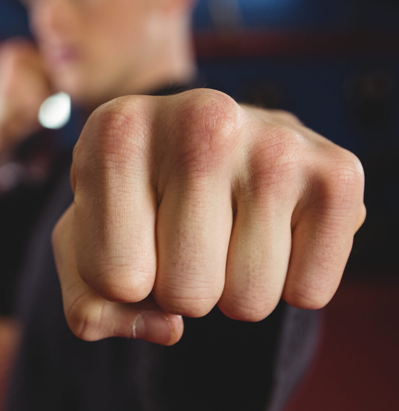 Karate player performing karate stance in fitness studio